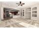 Comfortable living room featuring carpet flooring, a ceiling fan, and easy access to the adjacent kitchen at 17953 W Willow Dr, Goodyear, AZ 85338
