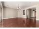 Spacious living room featuring hardwood floors, a stylish chandelier, and a seamless open floorplan at 17953 W Willow Dr, Goodyear, AZ 85338