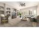 Comfortable living room with custom built-ins, lots of natural light, and ample seating for relaxation at 17953 W Willow Dr, Goodyear, AZ 85338