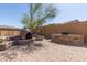 Outdoor kitchen with BBQ, pizza oven, seating, and custom stonework is perfect for entertaining and enjoyment at 17953 W Willow Dr, Goodyear, AZ 85338