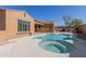 A backyard pool and spa is next to desert landscaping and a barbecue at 17953 W Willow Dr, Goodyear, AZ 85338