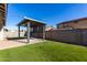 Backyard with artificial grass, paver patio, and a gazebo for outdoor enjoyment at 18735 W San Juan Ave, Litchfield Park, AZ 85340