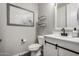 Stylish powder room with modern vanity, sleek fixtures, and rustic wood accents offers both functionality and aesthetic appeal at 18735 W San Juan Ave, Litchfield Park, AZ 85340