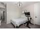 Bright bedroom with a modern light fixture and large window that offers natural light, creating a relaxing space at 18735 W San Juan Ave, Litchfield Park, AZ 85340