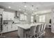 Spacious kitchen showcasing a center island with seating, stainless steel appliances, and ample counter space at 18735 W San Juan Ave, Litchfield Park, AZ 85340