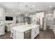 Modern kitchen with a large island, seating, and stainless-steel appliances at 18735 W San Juan Ave, Litchfield Park, AZ 85340