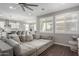 Comfortable living room boasting plantation shutters, a ceiling fan and an open layout that flows into the kitchen at 18735 W San Juan Ave, Litchfield Park, AZ 85340
