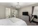 Bright main bedroom featuring a full length mirror, TV, dresser and treadmill in a neutral palette at 18735 W San Juan Ave, Litchfield Park, AZ 85340