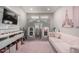 Charming playroom with a custom playhouse, comfortable seating, and soft, patterned rug at 18735 W San Juan Ave, Litchfield Park, AZ 85340