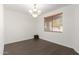 This dining room features hardwood floors, a chandelier, a window and neutral paint at 20257 N 63Rd Dr, Glendale, AZ 85308