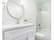 Stylish bathroom featuring a modern vanity, round mirror, and glass-enclosed shower at 20453 N 95Th Pl, Scottsdale, AZ 85255