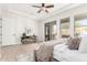 Bright primary bedroom with hardwood floors, ceiling fan, and sliding doors to patio at 20453 N 95Th Pl, Scottsdale, AZ 85255