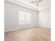 Empty bedroom filled with natural light, hardwood floors, and modern ceiling fan at 20453 N 95Th Pl, Scottsdale, AZ 85255