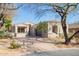 Charming single-story home with a well-manicured front yard and desert landscaping under a bright blue sky at 20453 N 95Th Pl, Scottsdale, AZ 85255