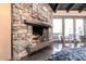 Stone fireplace with desert painting above and modern chairs in the background at 20453 N 95Th Pl, Scottsdale, AZ 85255
