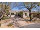 Charming single-story home with neutral stucco, a front patio, mature trees, and low-maintenance desert landscaping at 20453 N 95Th Pl, Scottsdale, AZ 85255