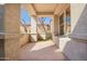 Covered front porch with textured columns and a view of the desert landscape at 20453 N 95Th Pl, Scottsdale, AZ 85255