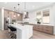 Modern kitchen with stainless steel appliances, a large island, and a sleek range hood at 20453 N 95Th Pl, Scottsdale, AZ 85255