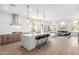 Open-concept kitchen with hardwood floors, a large island, stainless steel appliances, and modern lighting at 20453 N 95Th Pl, Scottsdale, AZ 85255