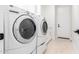 Close up on modern white washer and dryer in a bright laundry room at 20453 N 95Th Pl, Scottsdale, AZ 85255