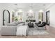 Bright living room features a gray sectional, modern fireplace, and neutral decor at 20453 N 95Th Pl, Scottsdale, AZ 85255