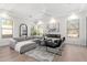 Beautiful living room with gray sofa, modern fireplace, and views from many windows at 20453 N 95Th Pl, Scottsdale, AZ 85255