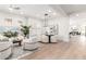 Open-concept living area with hardwood floors, neutral decor, and a dining area with modern lighting at 20453 N 95Th Pl, Scottsdale, AZ 85255