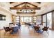 Interior view of a lounge area with a high beamed ceiling, stone walls, and multiple seating arrangements at 20453 N 95Th Pl, Scottsdale, AZ 85255