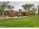 Outdoor seating area featuring lush lawn, cozy seating, and stylish patio umbrellas at 20453 N 95Th Pl, Scottsdale, AZ 85255