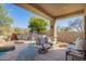 Covered patio with comfortable seating and views of the pool and outdoor kitchen at 20453 N 95Th Pl, Scottsdale, AZ 85255