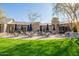 Patio area with tables and chairs with outdoor umbrellas and a small water feature at 20453 N 95Th Pl, Scottsdale, AZ 85255