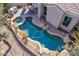 Aerial view of the home's outdoor pool and patio with rock features at 20453 N 95Th Pl, Scottsdale, AZ 85255