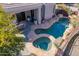 Aerial view of home's pool, hot tub, and patio with stone landscaping at 20453 N 95Th Pl, Scottsdale, AZ 85255