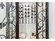 Climate-controlled wine storage with decorative iron door at 20453 N 95Th Pl, Scottsdale, AZ 85255