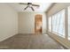 A serene bedroom with a ceiling fan and carpeted flooring leads to the Primary bathroom at 21122 W Sunrise Ln, Buckeye, AZ 85396