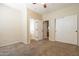 Bedroom showcasing an ensuite bathroom, carpeted flooring, and bi-fold closet doors at 21122 W Sunrise Ln, Buckeye, AZ 85396