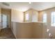 Upstairs hallway features arched windows and neutral paint at 21122 W Sunrise Ln, Buckeye, AZ 85396