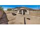 Spacious backyard features a covered patio area and low-maintenance desert landscaping at 21941 W Solano Dr, Buckeye, AZ 85326