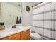Bathroom featuring a white shower curtain and green wreath at 21941 W Solano Dr, Buckeye, AZ 85326