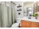 Bathroom with tub/shower combo with decorative shelving at 21941 W Solano Dr, Buckeye, AZ 85326