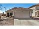 Charming single-story home with a well-manicured front yard and a two-car garage at 21941 W Solano Dr, Buckeye, AZ 85326