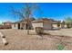 Lovely single-story home with desert landscaping, a driveway, and an attached two-car garage at 21941 W Solano Dr, Buckeye, AZ 85326