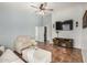 Inviting living room featuring tile floors, a ceiling fan, and comfortable seating at 21941 W Solano Dr, Buckeye, AZ 85326