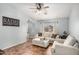 Comfortable living room with tile floors, a ceiling fan, and a plush sofa at 21941 W Solano Dr, Buckeye, AZ 85326