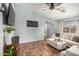 Comfortable living room with tile floors, a ceiling fan, and a plush sofa at 21941 W Solano Dr, Buckeye, AZ 85326