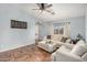 Cozy living room with tile floors, a ceiling fan, and a comfortable sofa at 21941 W Solano Dr, Buckeye, AZ 85326