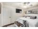 Comfortable main bedroom featuring dark wood floors and TV at 21941 W Solano Dr, Buckeye, AZ 85326