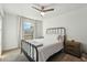 This cozy bedroom features a full bed, carpeted floor, and a large arched window at 2253 S Emerson --, Mesa, AZ 85210