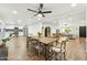 Open concept dining area flows into a living room and kitchen; features wood floors and ceiling fan at 2253 S Emerson --, Mesa, AZ 85210