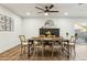 Dining room with exposed brick fireplace, ceiling fan, wood table, and chairs for six at 2253 S Emerson --, Mesa, AZ 85210